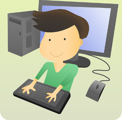 Boy in green shirt typing on comuputer keyboard